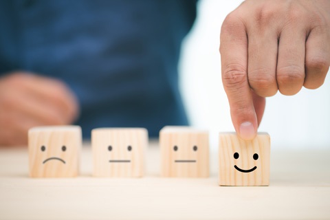 blocks of wood with happy and sad faces