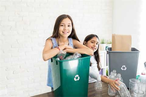 Two kids sorting recycling