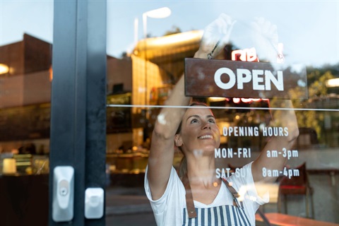 A person changes a store sign to 