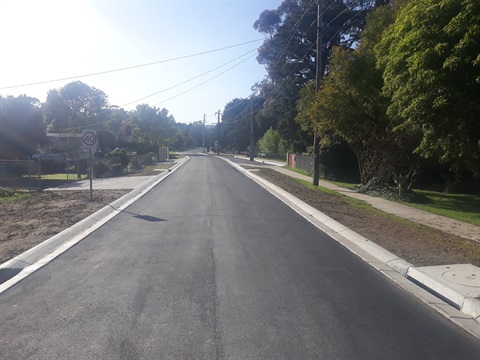 A sealed road, completed through the Roads for the Community initiative.