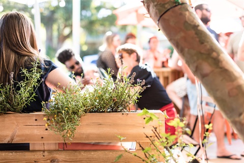 People enjoying an outdoor dining space.