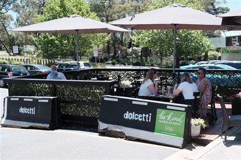 A photo of an outdoor dining area in Kilsyth, with people eating lunch.