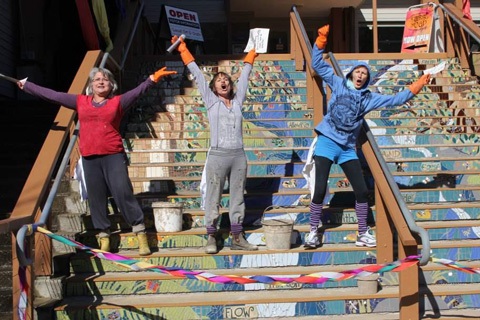 Artists on the stairs,  celebrating the opening of their work