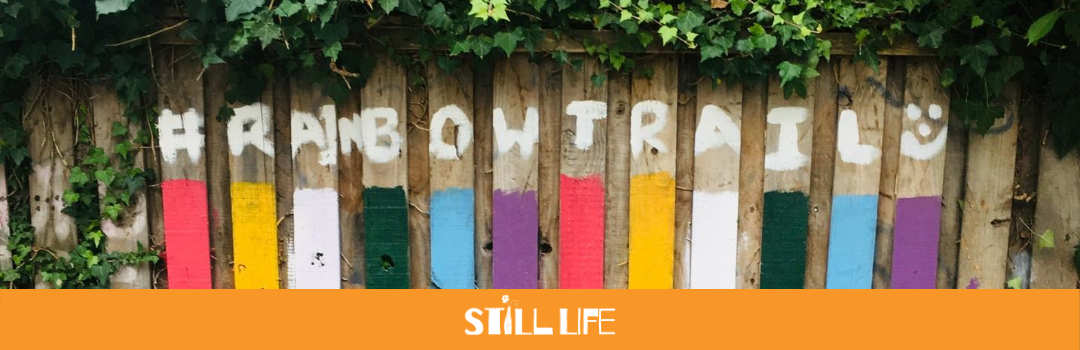 A rainbow painted on a fence