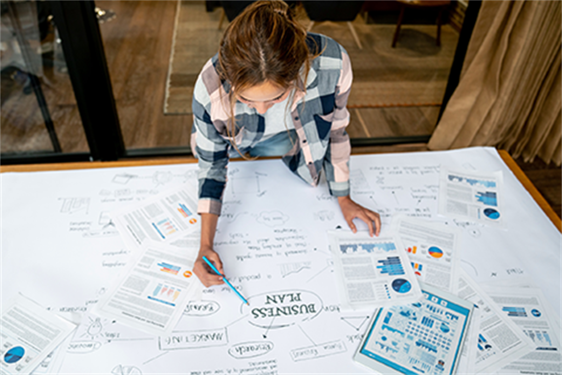 Person at a desk working on their business plan