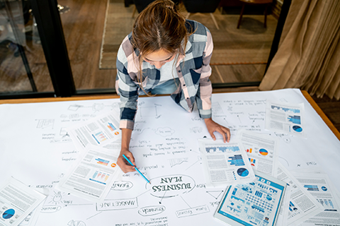 Person at a desk working on their business plan