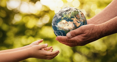 Adult passing the planet to a young person