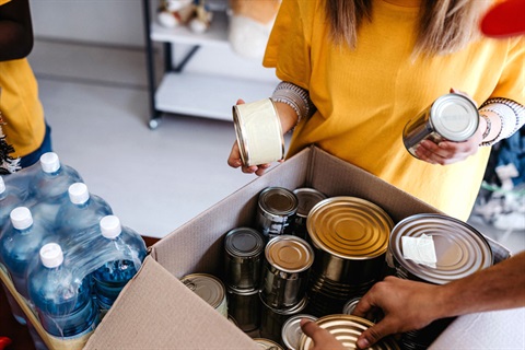 Volunteers packing a food package