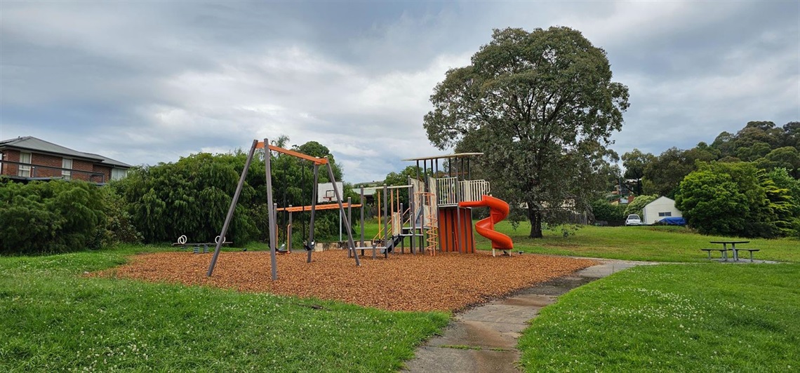 Play equipment with swings, slide, tower, climbing elements, basketball court