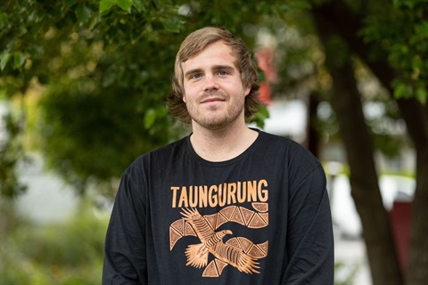 Nelson Aldridge stands in front of a tree in Healesville. His t-shirt reads 