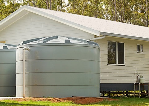 rain water tanks next to a house