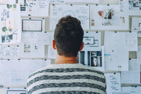 Person looking at a pin board with plans and ideas